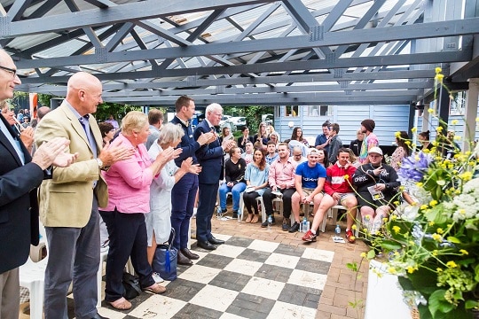 triple care farm graduation crowd clapping for young people