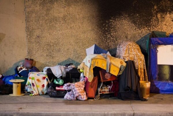 The side of a street with a person's belongings arranged along it