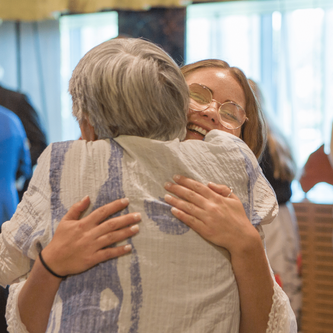 Young woman hugs older woman