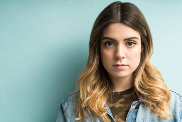 Young woman staring directly at the camera, looking serious