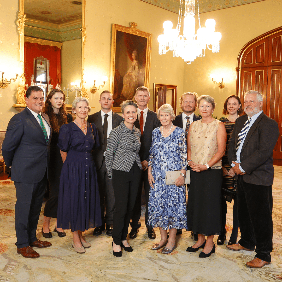 Eleven members of the Martin family standing together in evening dress at Government House