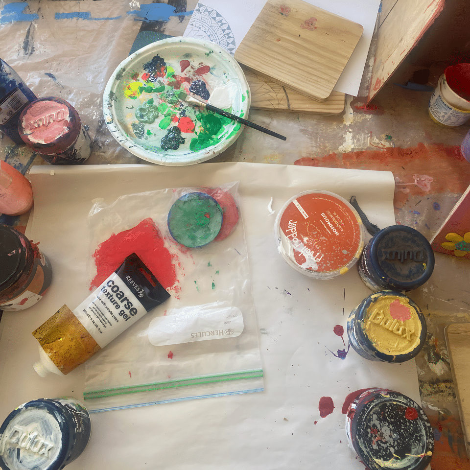 a selection of art supplies across a table