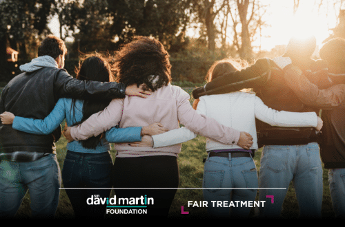 A group of people standing with their backs to the camera and linking arms. The Sir David Martin Foundation and Fair Treatment logos are at the bottom of the image.